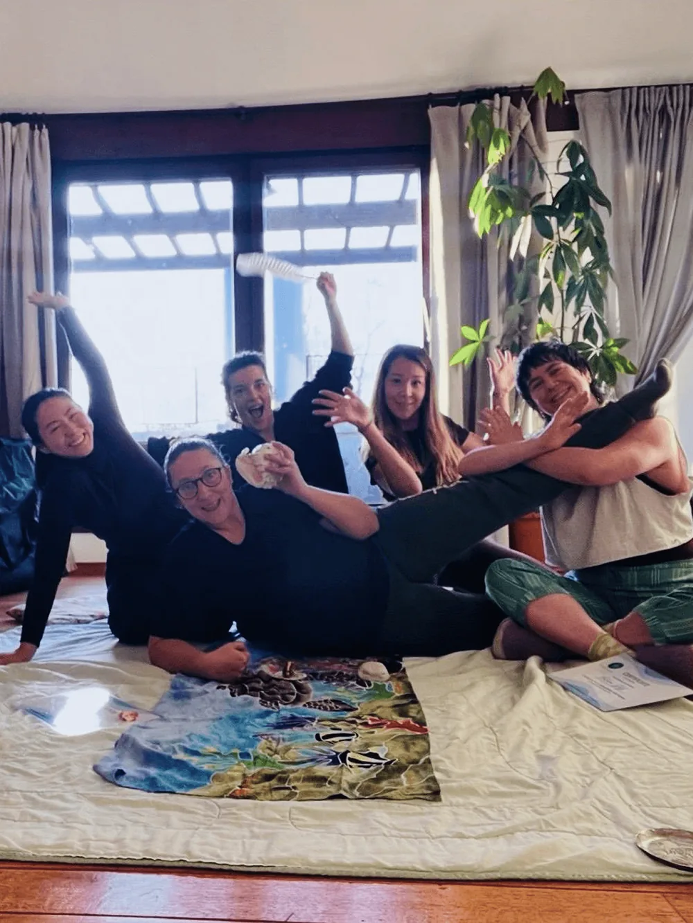 The Kahuna Bodywork training group, laughing together on the studio floor at the end of the course